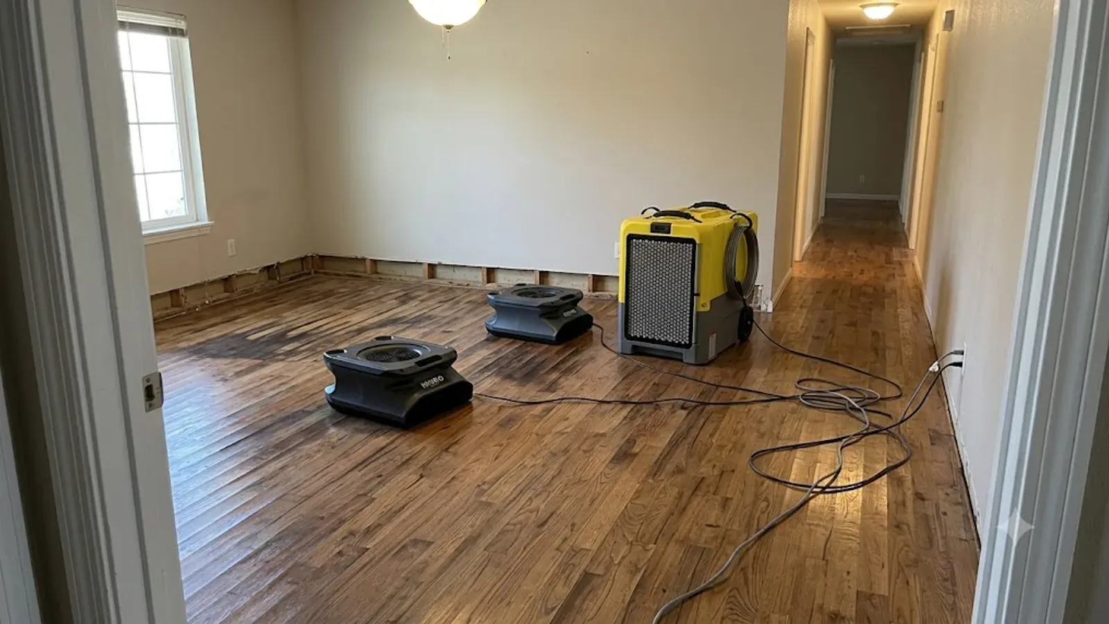 Drying equipment set up on a water-damaged wood floor in Bakersfield, CA